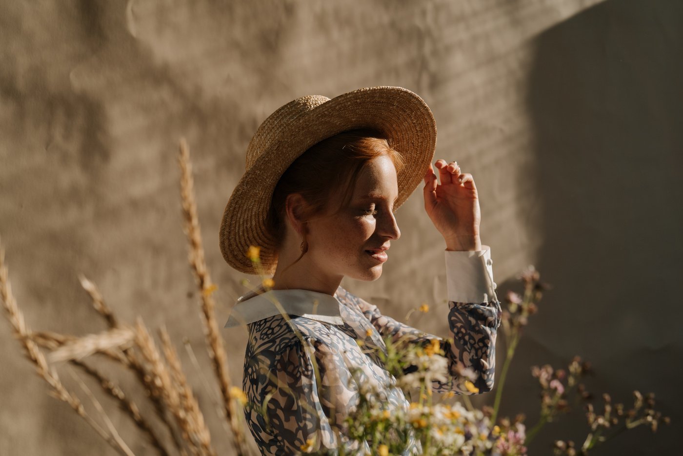 Woman in Brown Hat and White Blue and Yellow Floral Long Sleeve Shirt